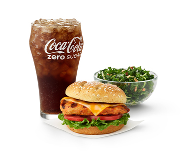  Grilled Spicy Deluxe Sandwich with a side of a Kale Crunch Salad and a glass of Coca-Cola Zero Sugar